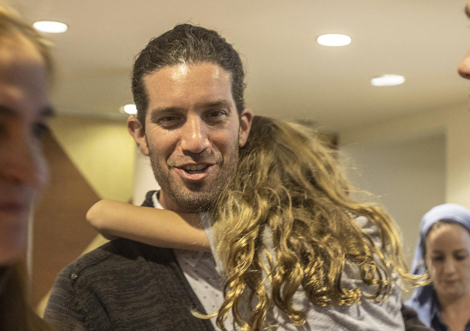Town of Surfside, Fla., newly elected Mayor Shlomo Dazinger holds his daughter as he celebrates with supporters after defeating incumbent Mayor Charles W. Burkett, during an election night at the Town Hall, on Tuesday March 15, 2022. (Pedro Portal/Miami Herald via AP)