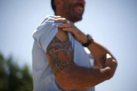 Citrus farmer John Gless displays a citrus-themed tattoo on Gless Ranch in Kern County, California, United States, July 23, 2015. REUTERS/Lucy Nicholson