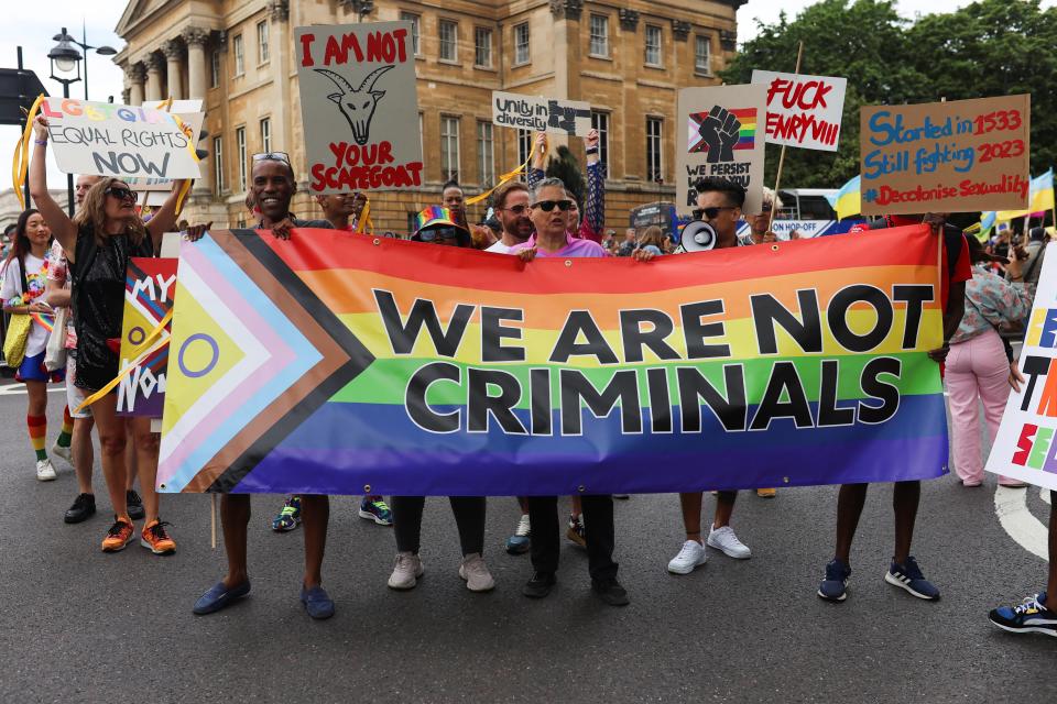 People carry a banner during the 2023 Pride Parade in London (REUTERS)