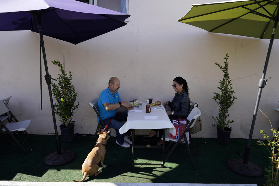 *** Hold For Story *** Steve Flores, left, has lunch with his cousin Carol Salter at Pie 'N Burger Tuesday, Dec. 1, 2020, in Pasadena, Calif. Pasadena has become an island in the center of the nation's most populous county, where a surge of COVID-19 cases last week led to a three-week end to outdoor dining and California's first stay-home order since the pandemic began to spread across the state in March. (AP Photo/Marcio Jose Sanchez)