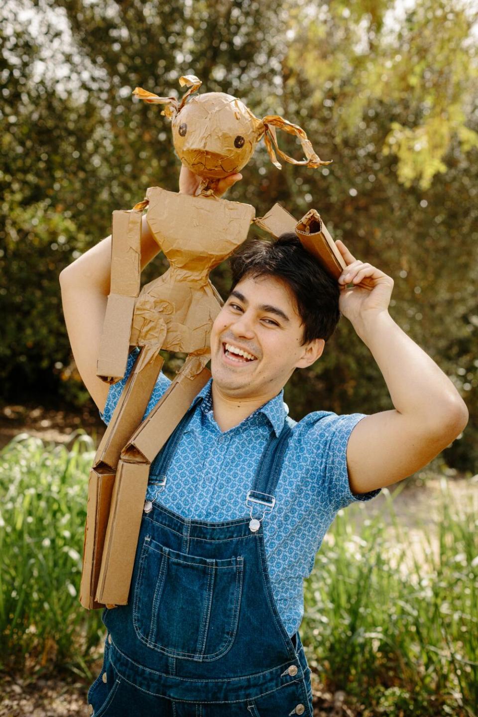 A mockup for a puppet sits on a person's shoulders.