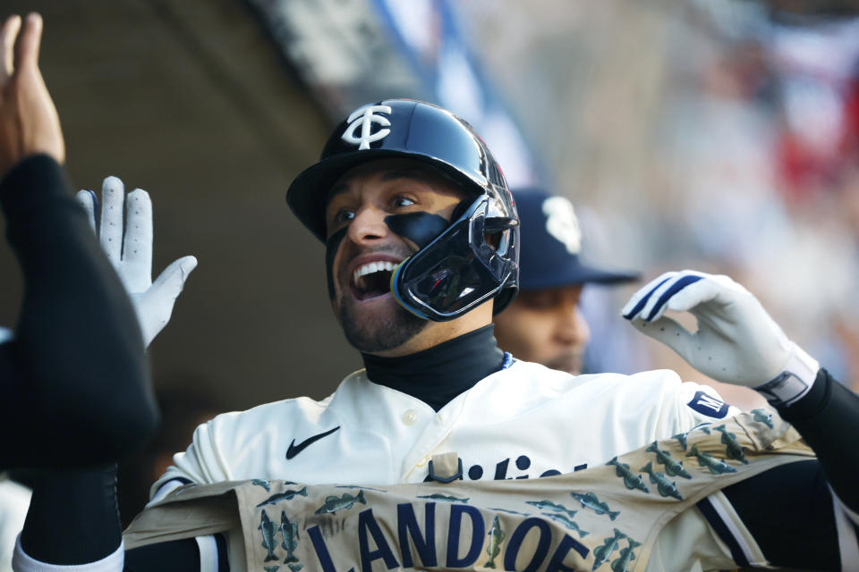 Minnesota Twins' Royce Lewis is greeted in the dugout after a solo home run during the first inning of Game 4 of a baseball AL Division Series against the Houston Astros, Wednesday, Oct. 11, 2023, in Minneapolis. (AP Photo/Bruce Kluckhohn)