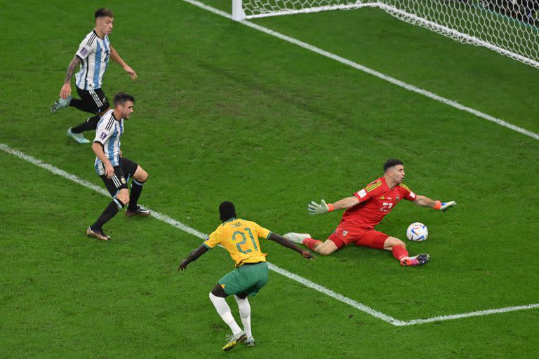 Argentina's goalkeeper #23 Emiliano Martinez saves a shot by Australia's forward #21 Garang Kuol during the Qatar 2022 World Cup round of 16 football match between Argentina and Australia at the Ahmad Bin Ali Stadium in Al-Rayyan, west of Doha on December 3, 2022. (Photo by Glyn KIRK / AFP)