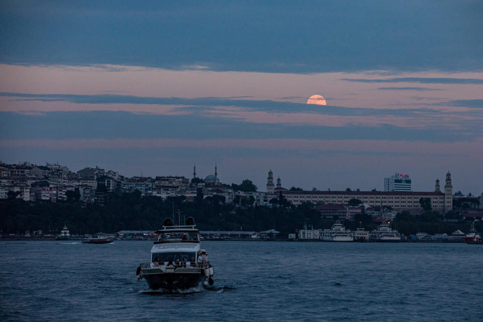 Super blood moon seen through the clouds in the sky. The super blood moon that emerged after the sunset in Istanbul in the evening was seen through the clouds. / Credit: Onur Dogman/Getty Images