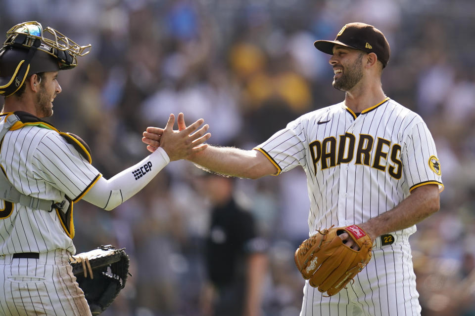 San Diego Padres relief pitcher Nick Martinez, right, celebrates with catcher Jorge Alfaro after the Padres defeated the Arizona Diamondbacks 10-4 in a baseball game Wednesday, June 22, 2022, in San Diego. (AP Photo/Gregory Bull)