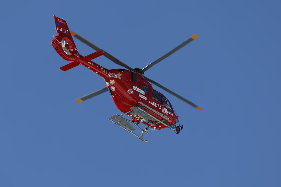 A helicopter flies evacuating United States' Mikaela Shiffrin after she crashed during an alpine ski, women's World Cup downhill race, in Cortina d'Ampezzo, Italy, Friday, Jan. 26, 2024. Shiffrin crashed into the safety nets after losing control landing a jump during a World Cup women's downhill on Friday. (AP Photo/Alessandro Trovati)