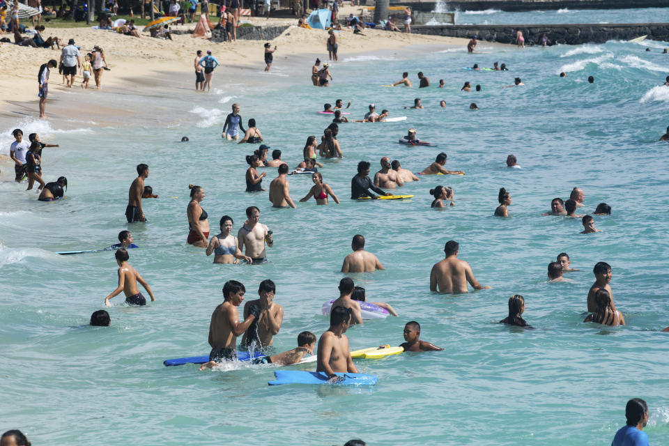 Swimmers, boogie boarders and surfers made good good use high swells in Waikiki, Hawaii, Sunday, July 17, 2022. (Craig T. Kojima/Honolulu Star-Advertiser via AP)