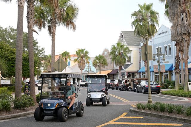 <p>AP Photo/Phelan M. Ebenhack, File</p> Lake Sumter Landing Market Square in The Villages