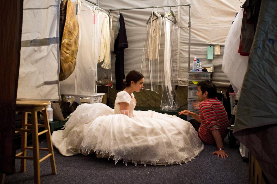 Director Tarsem Singh reviews a scene with star Lily Collins on the set of Relativity Media's Mirror Mirror.