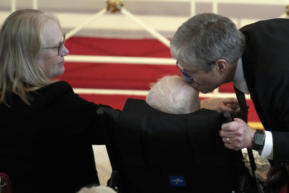 James "Chip" Carter kisses the forehead of his father, former President Jimmy Carter, as Amy Carter watches, during a tribute service for former first lady Rosalynn Carter, at Glenn Memorial Church, in Atlanta, Tuesday, Nov. 28, 2023. (AP Photo/Andrew Harnik)