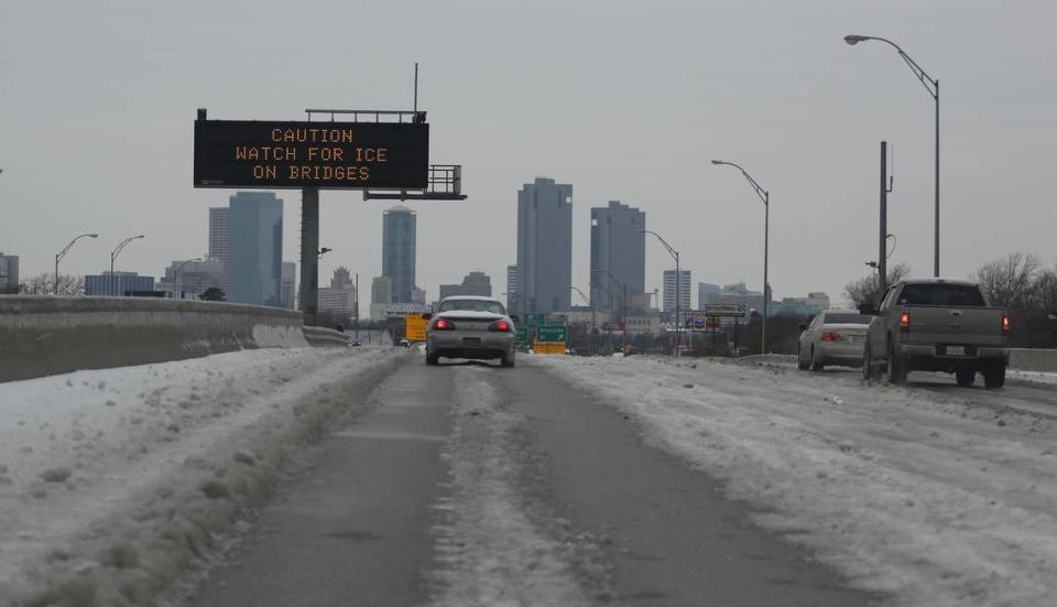 Signs warn of treacherous conditions on Highway 121 in Fort Worth. Ice remains after low temperature refroze sleet from the day before’s storm that had begun to melt.