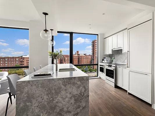 The kitchen at BLVD with an island and view of the city out the window