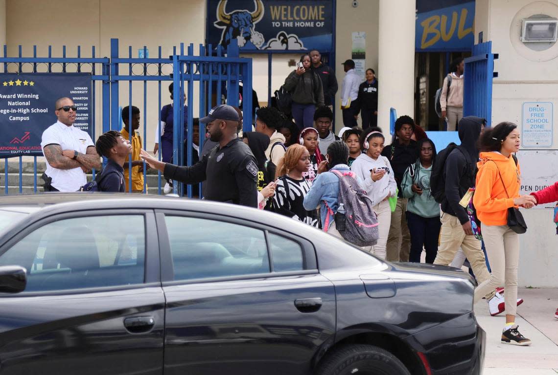 Miami-Dade Public Schools police officers wait outside as students exit Miami Northwestern Senior High in Miami, Florida, Friday, January 12, 2024. Miami-Dade Public Schools increased its police presence at the school the day after a student was shot on campus following a boys basketball game.