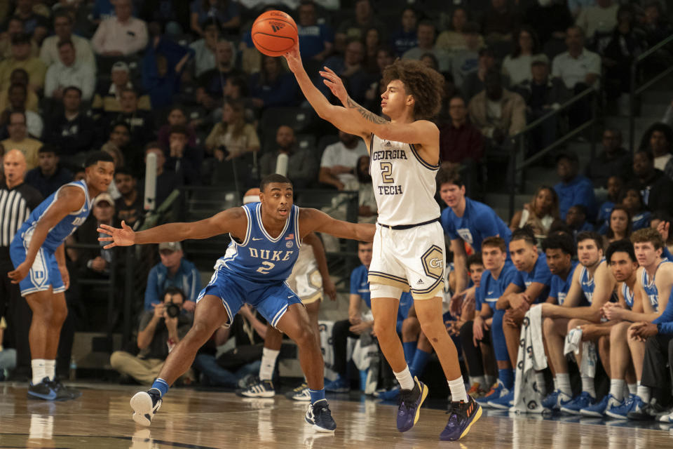 Georgia Tech guard Naithan George (2) passes over Duke guard Jaylen Blakes (2) in the first half of an NCAA college basketball game Saturday, Dec. 2, 2023, in Atlanta. (AP Photo/Hakim Wright Sr.)