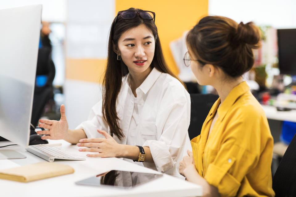 Business people are discussing in the office and telling a story about friends among colleagues.