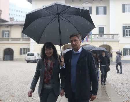 Presidential candidate Borut Pahor and his wife Tanja Pecar walk after casting their votes in the presidential election in Sempeter pri Novi Gorici, Slovenia October 22, 2017. REUTERS/Srdjan Zivulovic