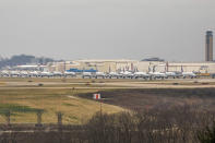 Dozens of parked American Airlines planes are parked at the Pittsburgh International Airport, Friday, March 27, 2020, in Moon, Pa. The airport has become a parking destination for the airline during the COVID-19 shutdown. (Andrew Rush/Pittsburgh Post-Gazette via AP)
