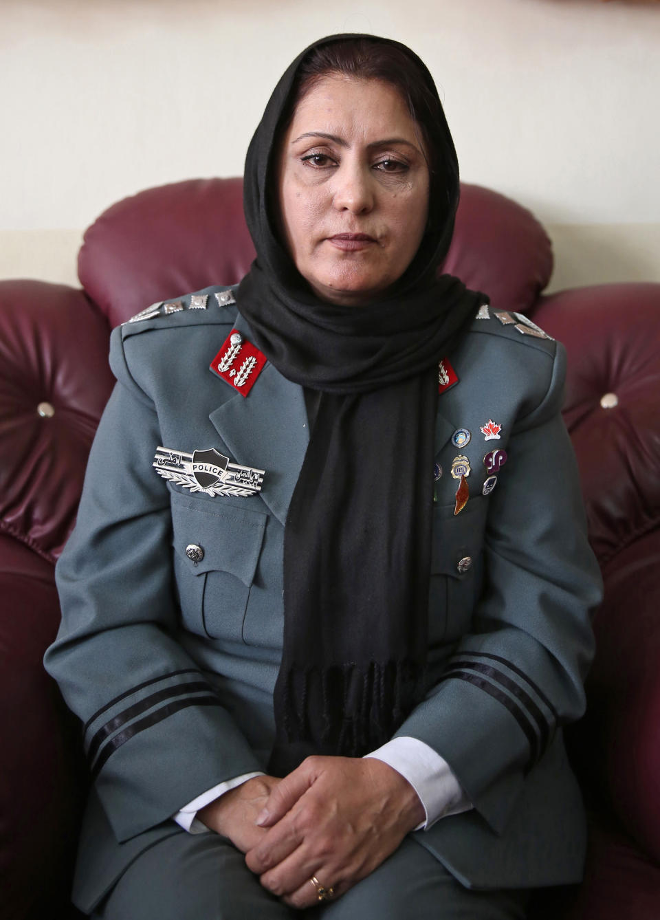 Afghanistan's first-ever female district police chief, Col. Jamila Bayaz, 50, poses for a photo during an interview at her office in Kabul, Afghanistan, Thursday, Jan. 16, 2014. Afghanistan's first-ever female district police chief drew stares on Thursday as she drove and walked around the center of the city, reviewing check points and some of the important business and administrative facilities she is tasked with protecting. (AP Photo/Massoud Hossaini)