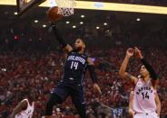 Apr 13, 2019; Toronto, Ontario, CAN; Orlando Magic guard D.J. Augustin (14) goes up to make a basket as Toronto Raptors guard Danny Green (14) looks on during game one of the first round of the 2019 NBA Playoffs at Scotiabank Arena. Orlando defeated Toronto. Mandatory Credit: John E. Sokolowski-USA TODAY Sports