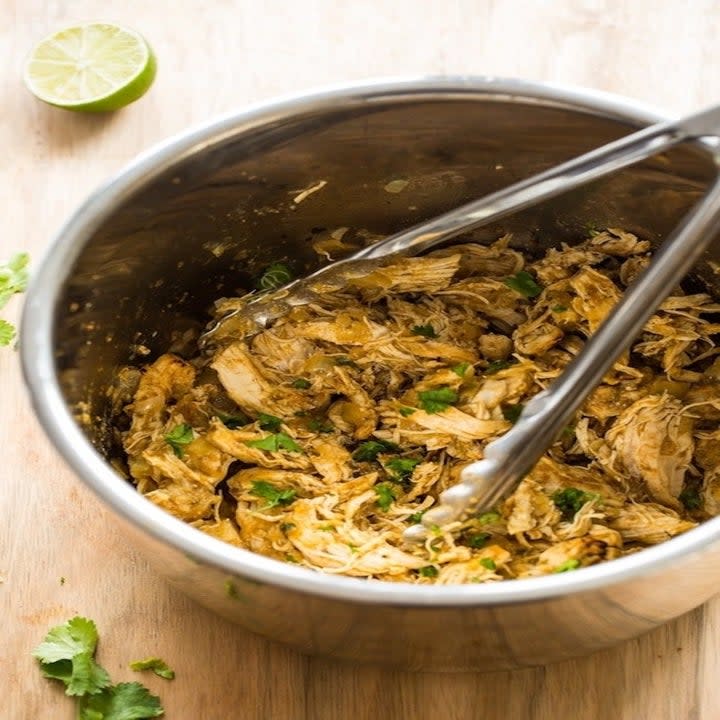An Instant Pot filled with shredded chicken carnitas