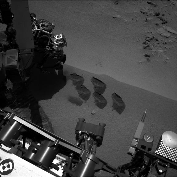 Bite-marks on Mars. NASA’s Mars rover Curiosity used a mechanism on its robotic arm to dig up five scoopfuls of material from a patch of dusty sand called “Rocknest.” Each of the pits is about 2 inches (5 centimeters) wide. A sample from that