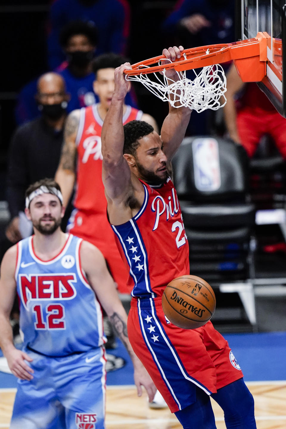 Philadelphia 76ers' Ben Simmons dunks in front of Brooklyn Nets' Joe Harris during the first half of an NBA basketball game Thursday, Jan. 7, 2021, in New York. (AP Photo/Frank Franklin II)