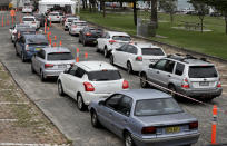 People queue at a drive through COVID-19 testing station at a beach in Sydney, Australia, Saturday, Dec. 19, 2020. Sydney's northern beaches will enter a lockdown similar to the one imposed during the start of the COVID-19 pandemic in March as a cluster of cases in the area increased to more than 40. (AP Photo/Mark Baker)