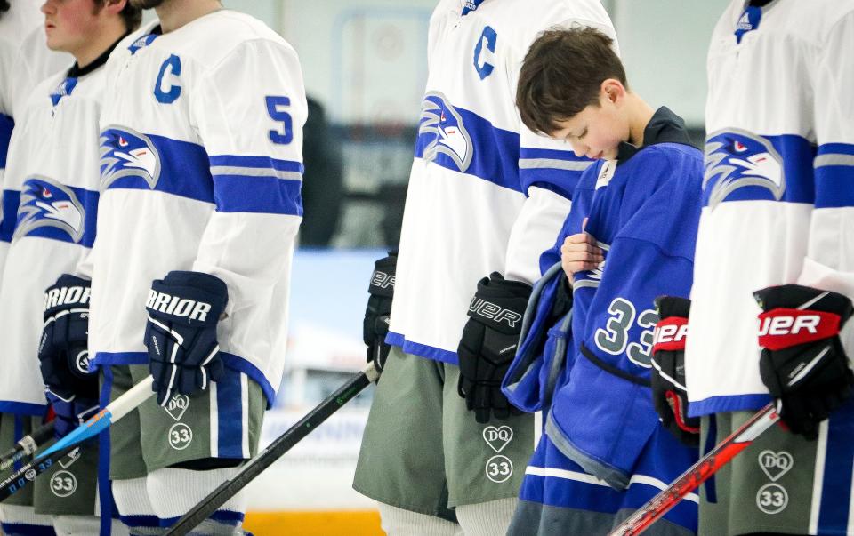 Connor Quinn, 11, younger brother of Dylan Quinn, during the national anthem before Southeastern/Bristol-Plymouth hockey team played a game against South Shore Tech at Raynham IcePlex on Saturday, Jan. 21, 2023.