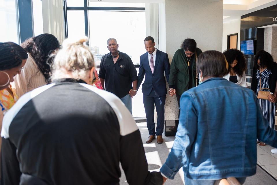Former Florida State University football player Travis Rudolph holds hands with friends and family during a prayer circle while awaiting the jury's verdict in his murder trial on Wednesday, June 7, 2023, in the Palm Beach County Courthouse in downtown West Palm Beach, Fla.