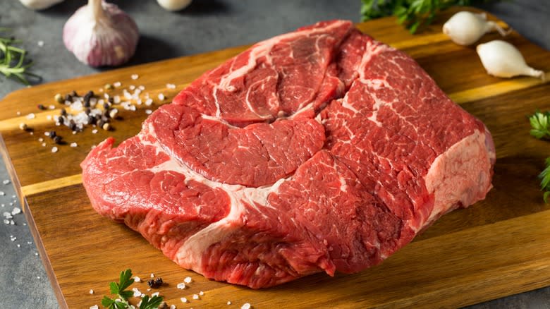 Raw chuck roast on cutting board 