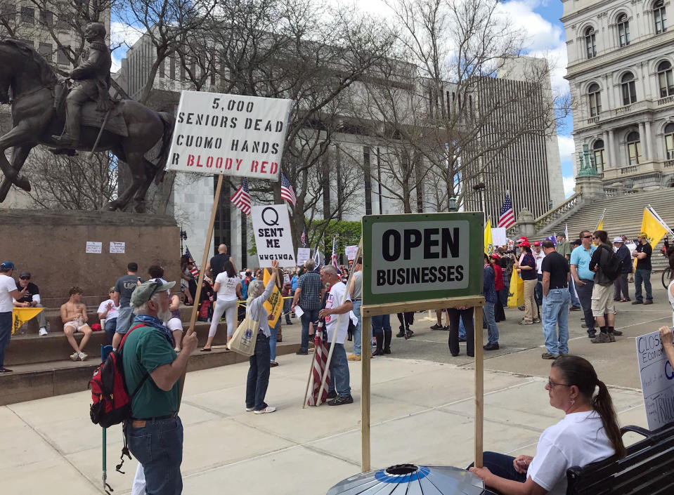 Protesters gather near the State Capitol in Albany, N.Y., calling for the state to reopen the economy, Saturday, May 16, 2020. During N.Y. Gov. Andrew Cuomo's news conference on Saturday, he mention some additional loosening up of COVID-19 related restrictions but cautioned that the state could see a rise in cases as the economy opens up. To avoid another spike, people will still need to take precautions like social distancing, he said. (AP Photo/Marina Villeneuve)