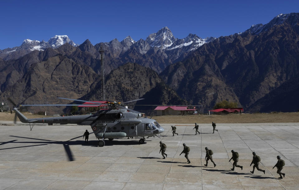 Indian army soldiers run to board a helicopter during Indo-US joint exercise or "Yudh Abhyas, in Auli, in the Indian state of Uttarakhand, Tuesday, Nov. 29, 2022. Militaries from India and the U.S. are taking part in a high-altitude training exercise in a cold, mountainous terrain close to India's disputed border with China. The training exercise began two weeks ago. India's defence ministry statement said the joint exercise is conducted annually with the aim of exchanging best practices, tactics, techniques and procedures between the armies of the two nations, which is under Chapter of the UN Mandate. (AP Photo/Manish Swarup)