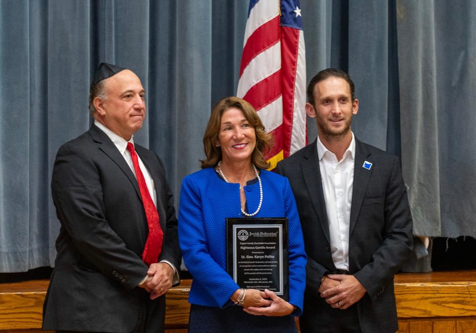 City Councilor Moe Bergman, left, and Steven Schimmel, executive director of the Jewish Federation of Central Massachusetts, present former Lt. Gov. Karyn Polito the Righteous Gentile Humanitarian Award Wednesday in Worcester.