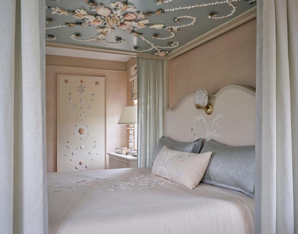 A wall panel featuring a custom de Gourney fabric embroidered with three-dimensional seashells complements the shells elsewhere in the bedroom designed by Cindy Rinfret at the Kips Bay Decorator Show House Palm beach.