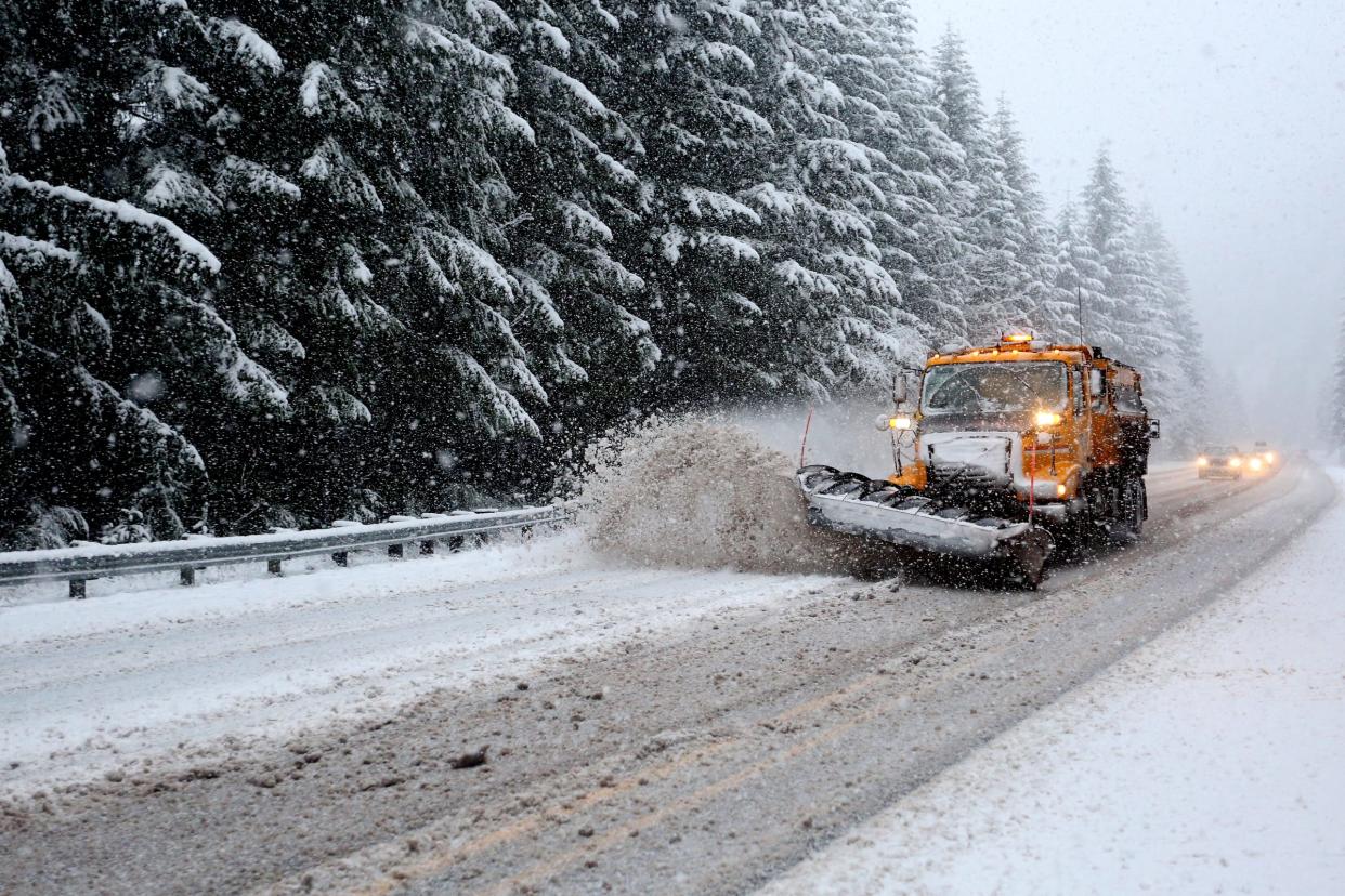 A snowplow makes a run on the highway near Detroit Lake in this file photo.