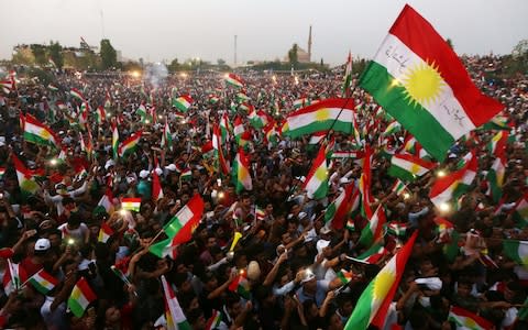 Iraqi Kurds fly Kurdish flags during an event to urge people to vote in the upcoming independence referendum in Arbil, the capital of the autonomous Kurdish region of northern Iraq, on September 16, 2017. / - Credit: AFP