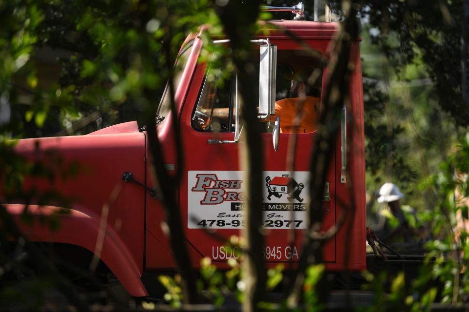 Joey Jackson with Fish Brothers House Movers drives the truck to move the historic Fordyce-Kennedy-Pritchard House from McDowell Street to its new location on East Avenue on Thursday, Sept. 7, 2023.