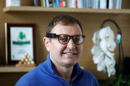 Ziv Aviram, CEO and co-founder of OrCam, poses for a portrait wearing the OrCam MyEye 2.0 device attached to a pair of glasses in his office in Jerusalem, February 15, 2018. REUTERS/Nir Elias