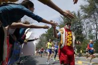 FILE -- In this April 15, 2013, file photo, a man dressed as a hot dog runs through Wellesley, Mass., during the 117th running of the Boston Marathon. Due to the COVID-19 virus pandemic, the 124th running of the Boston Marathon was postponed from its traditional third Monday in April to Monday, Sept. 14, 2020. (AP Photo/Michael Dwyer, File)