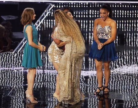 Beyonce accepts the Female Video of the Year award from U.S. Olympic gymnasts Madison Kocian, Aly Raisman, Simone Biles and Laurie Hernandez during the 2016 MTV Video Music Awards in New York, U.S., August 28, 2016. REUTERS/Lucas Jackson