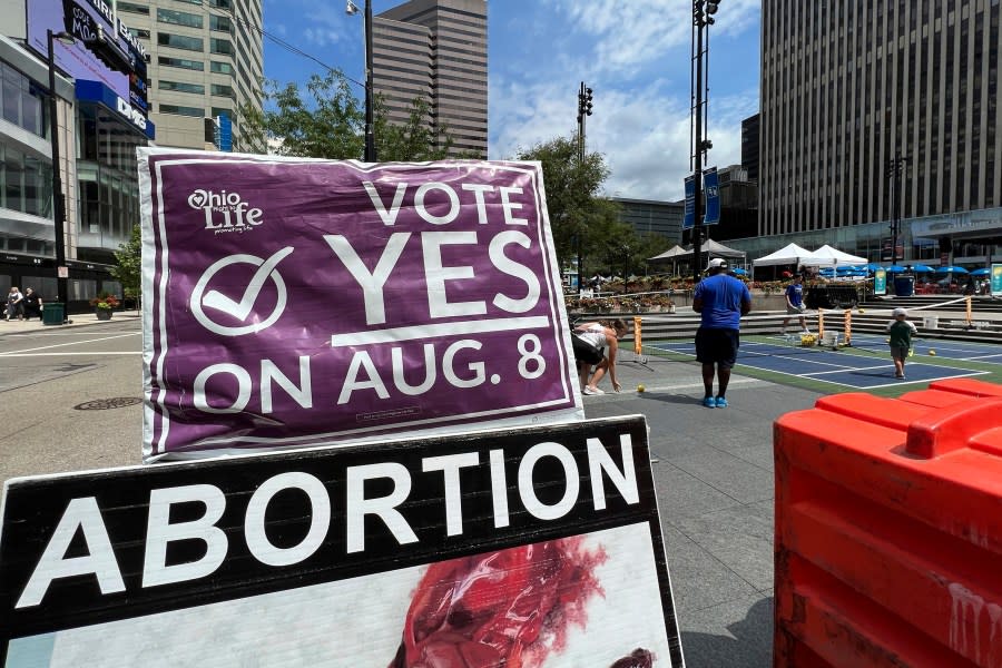 A sign asking Ohioans to vote in support of Issue 1 sits above another sign advocating against abortion rights at an event hosted by Created Equal on July 20, 2023, in Cincinnati, Ohio. (AP Photo/Patrick Orsagos, File)