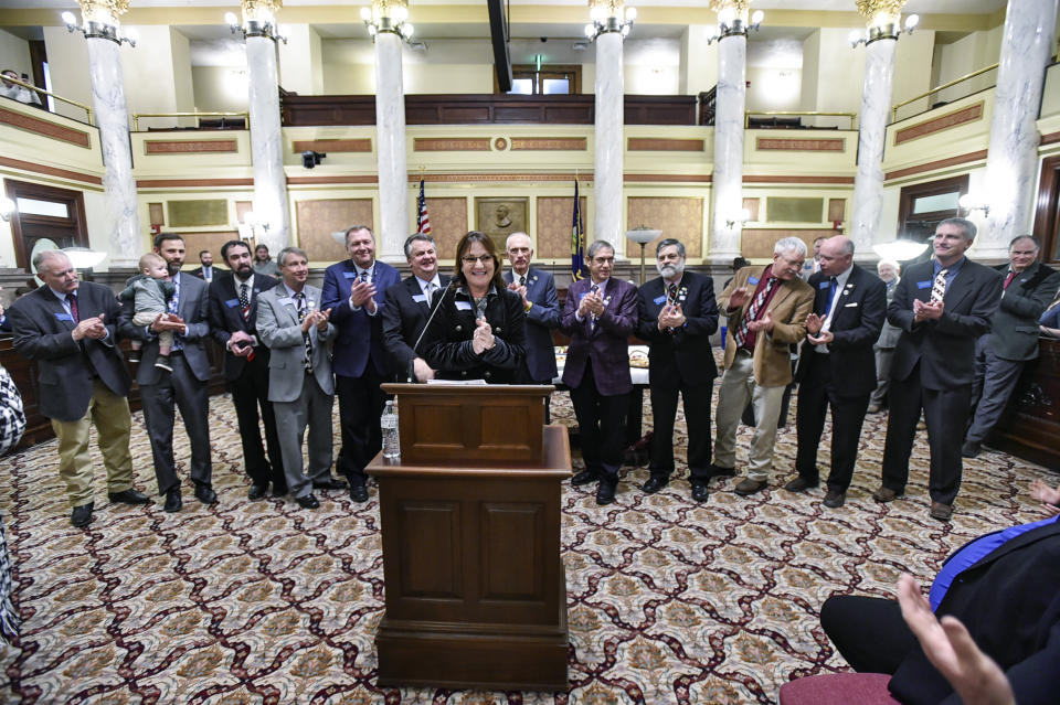 FILE - Republican Sen. Theresa Manzella, at podium, is shown with members of the conservative Montana Freedom Caucus in the Old Supreme Court chambers at the Montana State Capitol on Jan. 19, 2023. The banishment of transgender lawmaker Zooey Zephyr from Montana's House floor has showcased the rising power of hardline conservatives who are leveraging divisive social issues to gain political influence. (Thom Bridge/Independent Record via AP, File)
