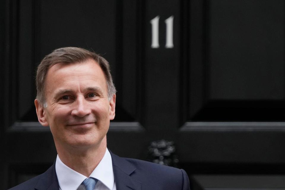 Britain's Chancellor of the Exchequer Jeremy Hunt poses for the media as he leaves 11 Downing Street for the House of Commons to deliver the Budget In London, Wednesday, March 15, 2023. (AP Photo/Frank Augstein)