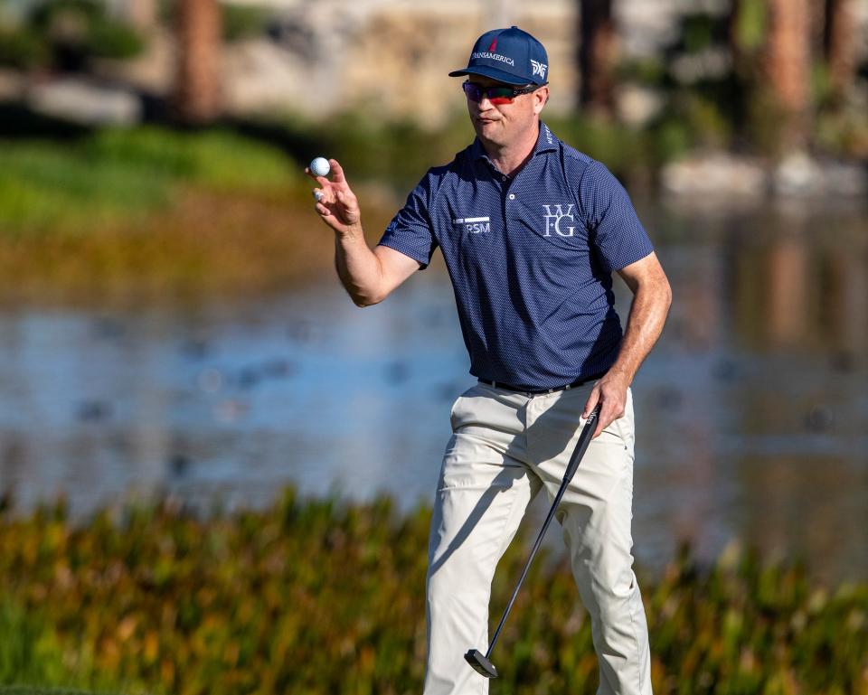 Zach Johnson holds up his ball to the gallery after finishing up on the 18th green during Round 1 of The American Express at La Quinta Country Club in La Quinta, Calif., Thursday, Jan. 18, 2024.