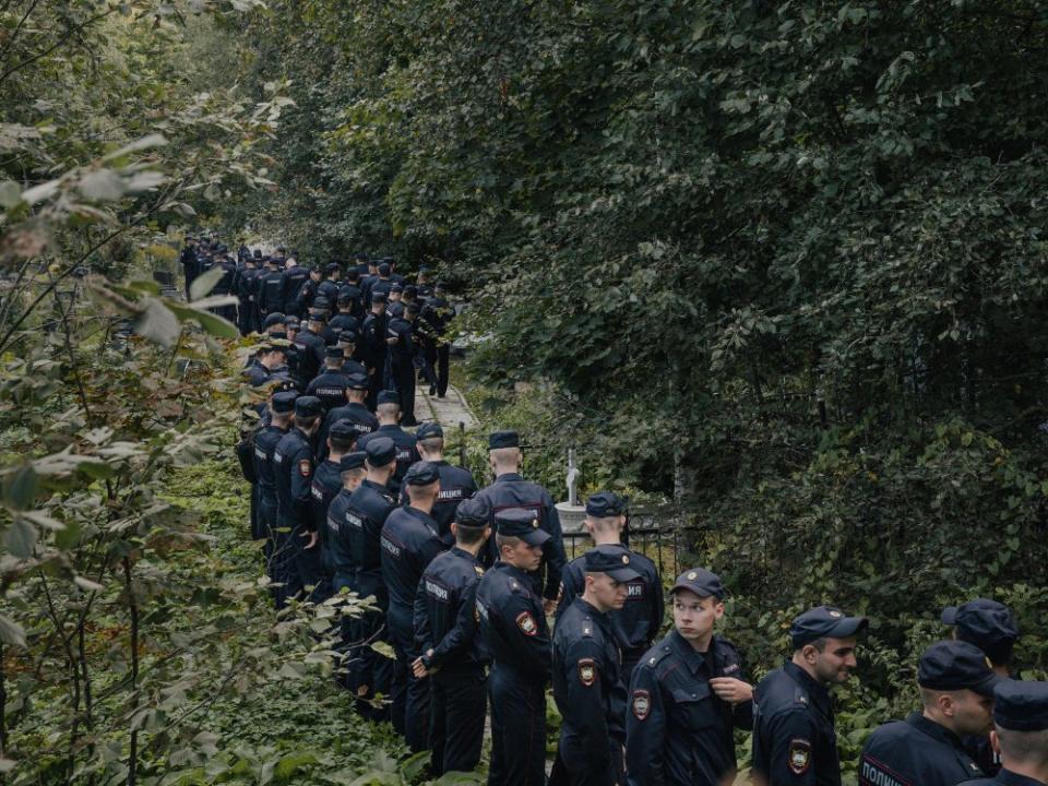 Police officers at the Porokhovskoye cemetery, where the press service owned by Yevgeny Prigozhin said he was buried, in St. Petersburg, Russia, on Aug. 29. The announcement of the burial of the Russian mercenary chief who died in a plane crash ended days of speculation over how he would be laid to rest.<span class="copyright">Nanna Heitmann—The New York Times/Redux</span>