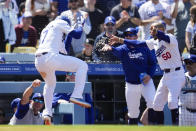 Los Angeles Dodgers' Teoscar Hernández (37) celebrates with Max Muncy, second from right, and Mookie Betts (50) after hitting a home run during the sixth inning of a baseball game against the Atlanta Braves in Los Angeles, Sunday, May 5, 2024. (AP Photo/Ashley Landis)