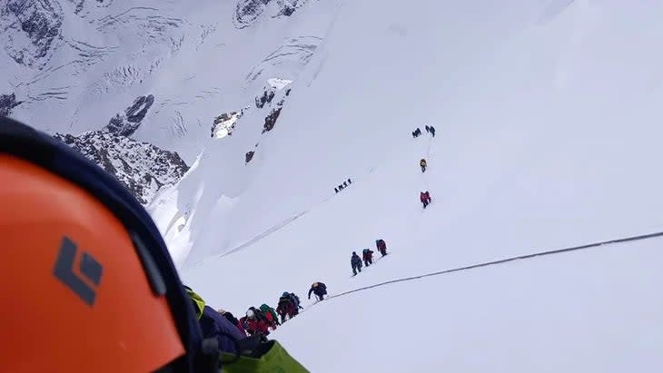  In this image, the line of climbers can be seen snaking down the glacier. 