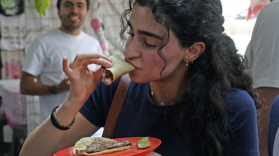 A diner tucks into one of popular tacos at the no frills eatery in Mexico City. - Silvana Flores/AFP/Getty Images