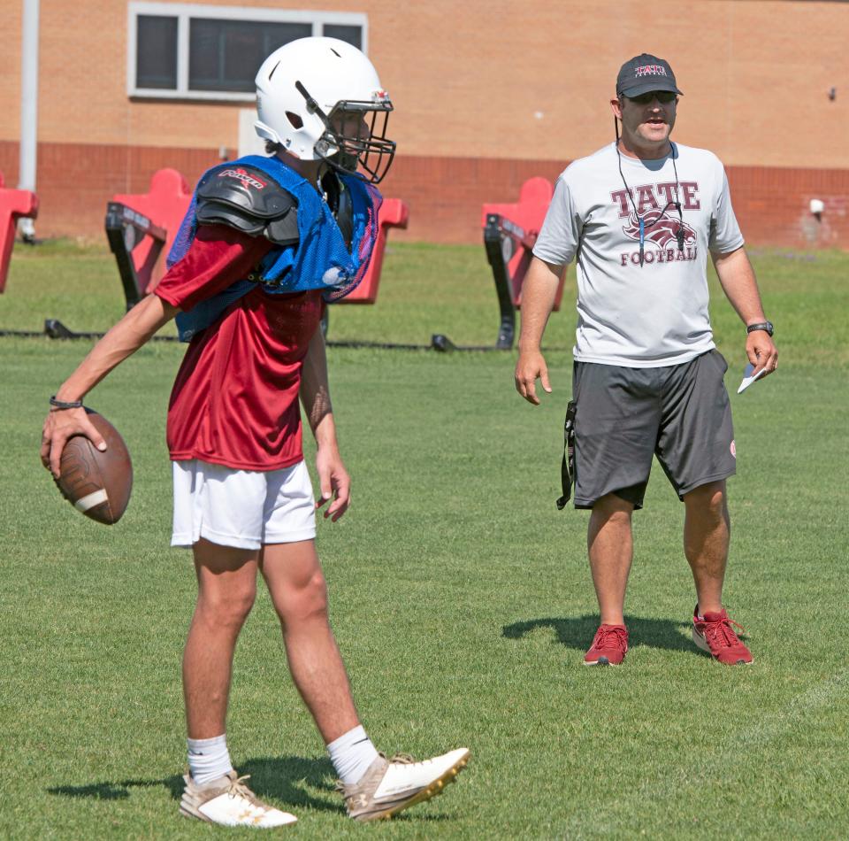 Tate Football coach Rhett Summerford encourages his players during spring football practice on Wednesday, May 1, 2024.