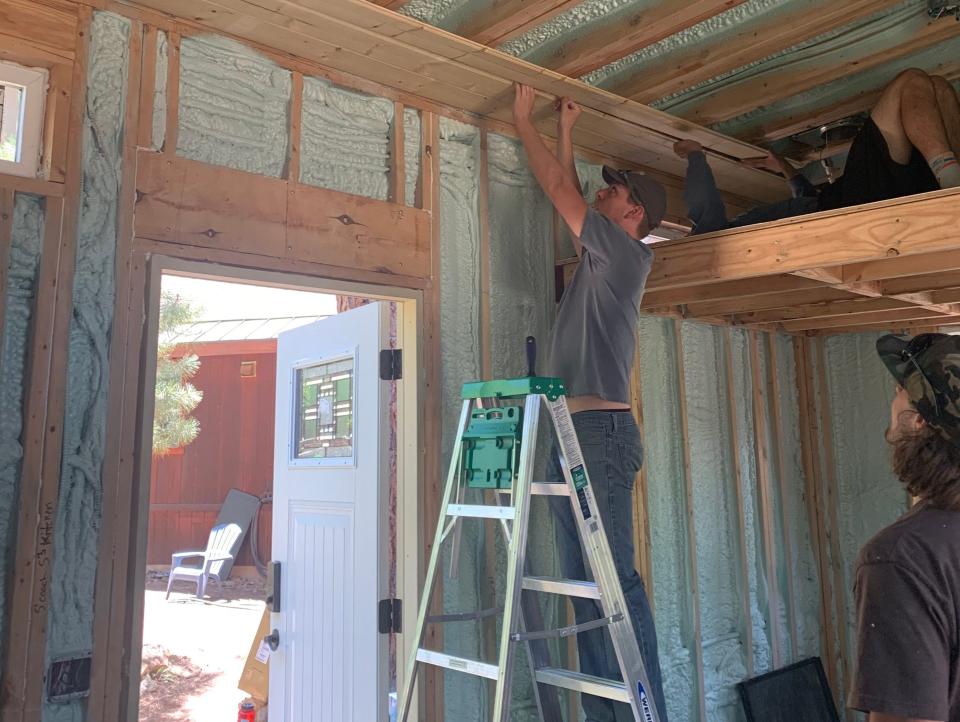 people building a tiny home